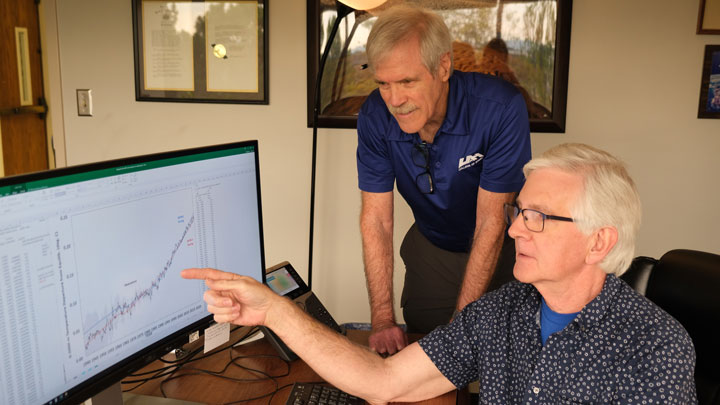 Left to Right: UAH’s Dr. John Christy reviews climate model data with Dr. Roy W. Spencer