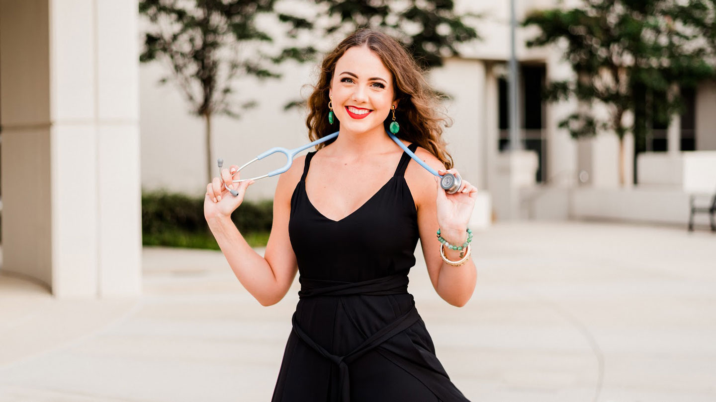 UAH honors nursing student smiling and holding a stethoscope