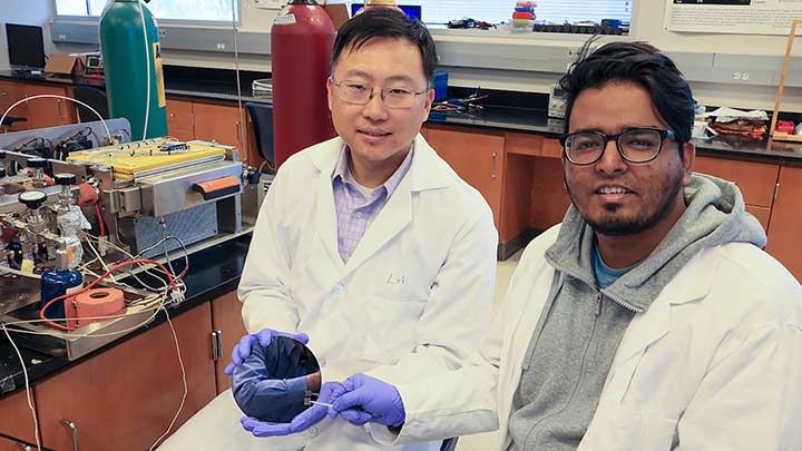 Dr. Yu Lei and post-doctoral student Muntaseer Benian in lab coats