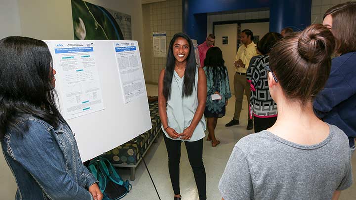 ALSAMP students present their research at a recent event.