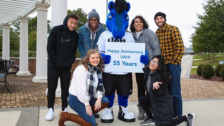 Students posing outside with UAH mascot. ?>