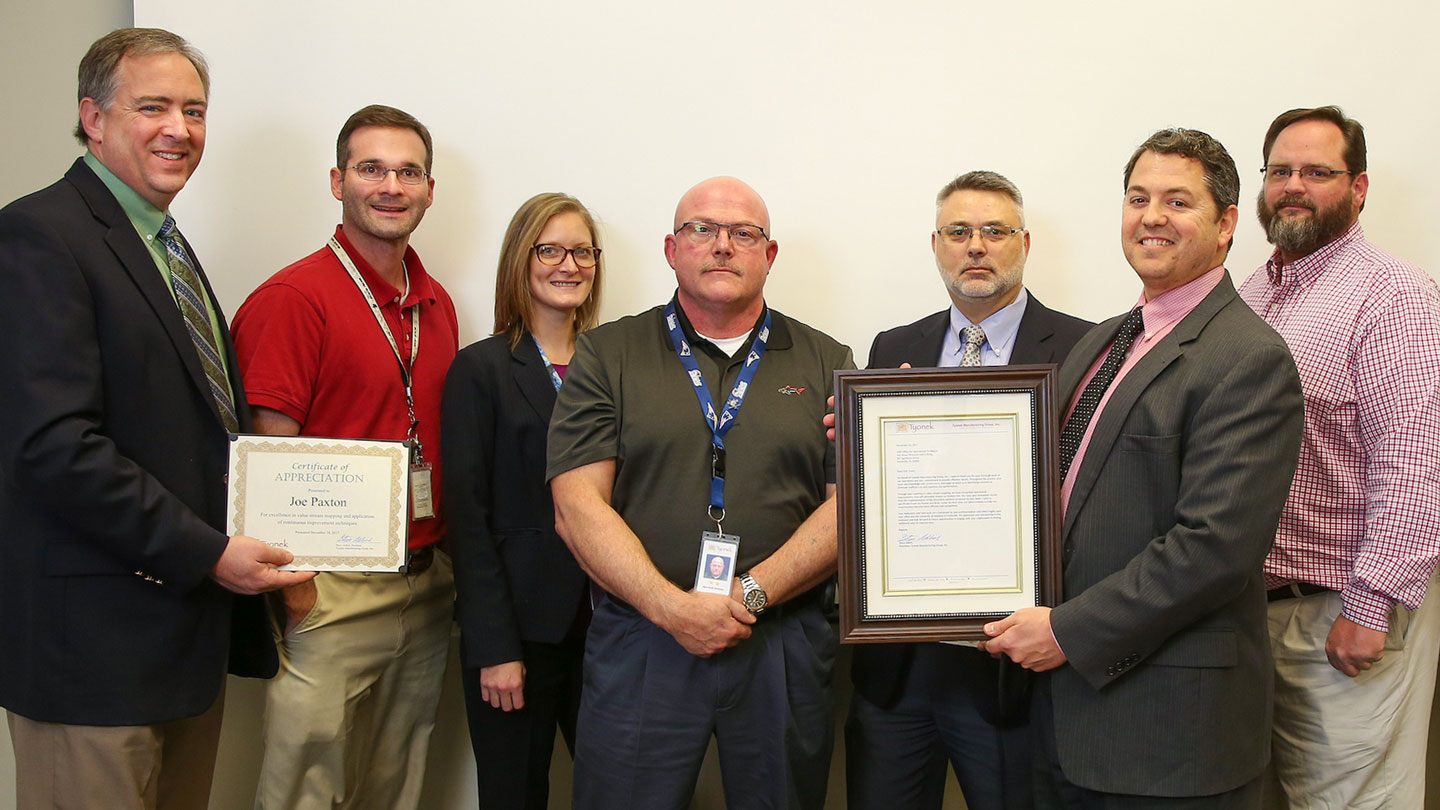 Representatives of O O E and the Tyonek Native Corporation exchange certificates of appreciation