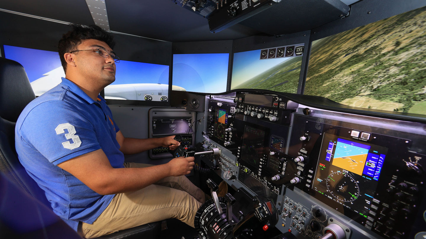 A student uses a flight simulator