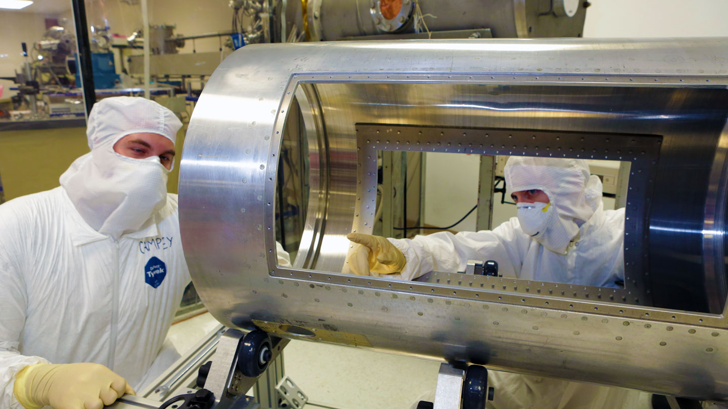 Students examine equipment in a clean room