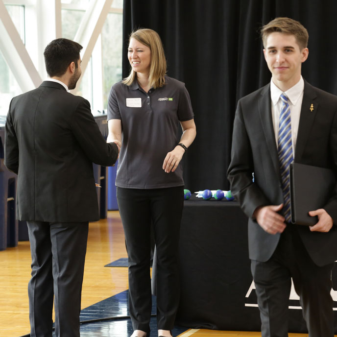 An Adtran human resources representative meets with U A H students at a career fair