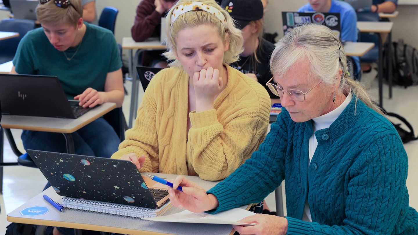 U A H instructor Genevieve Crook helps a curious student complete a differential equation