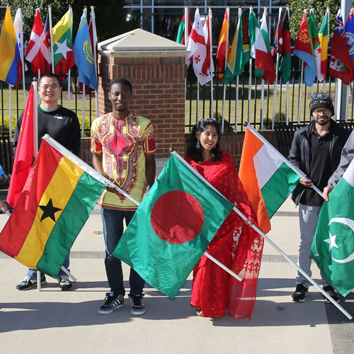 U A H students pose with flags representing China, Ghana, Bangladesh, India, and Pakistan