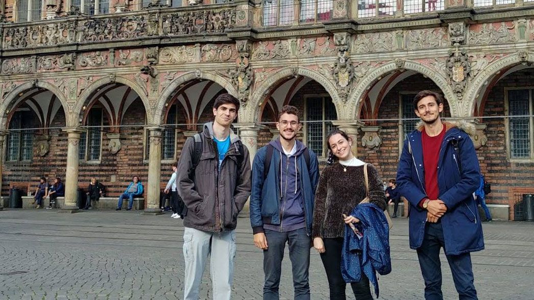 A group of students poses outside of the ornate 13th-century City Hall building in Bremen, Germany.