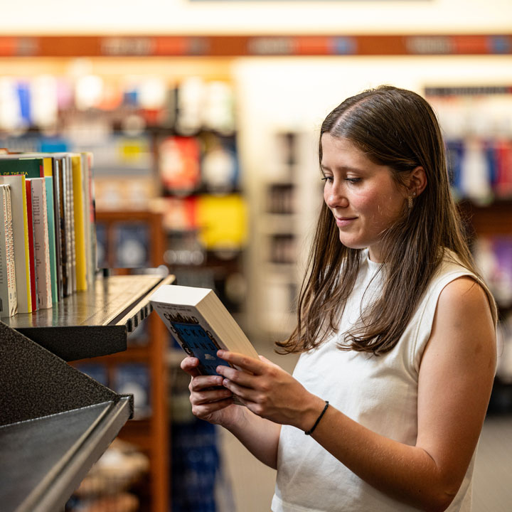 A U A H student browses books in the bookstore.