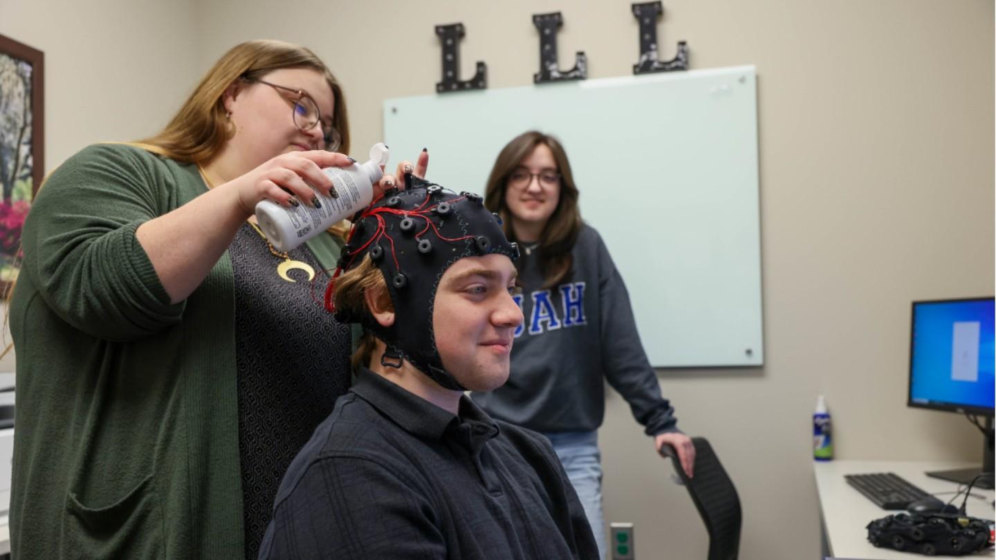 a cranial cap is put on a man's head