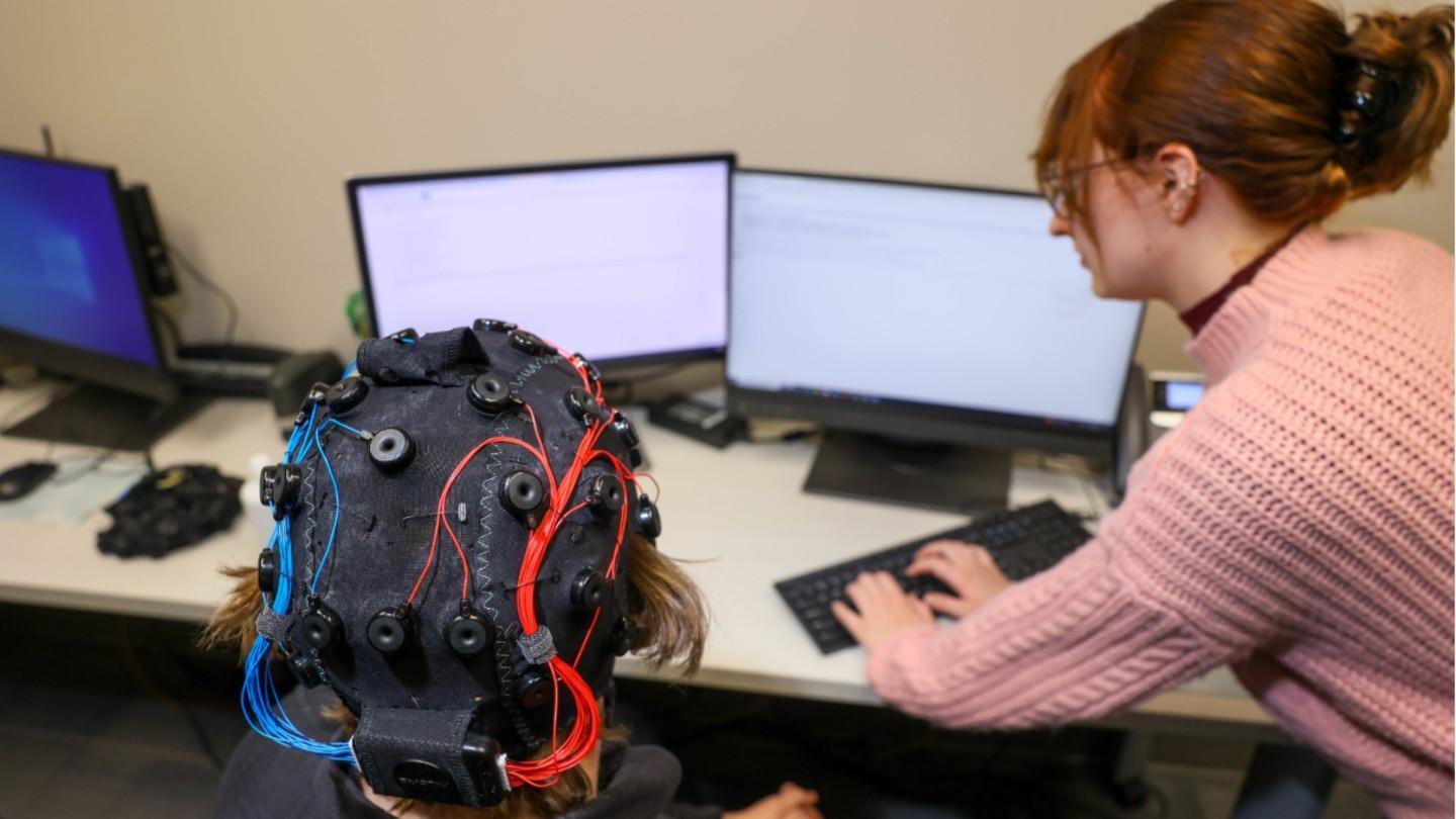 a woman examines the results of a electrical pulse scanning head cap