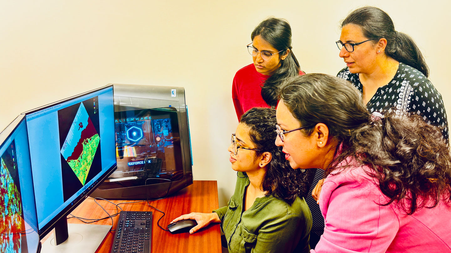 Dr. Chaity Banerjee Mukherjee with computer science students. The researcher is developing frameworks for artificial neural networks that will help combat RF “spoofing” attacks.