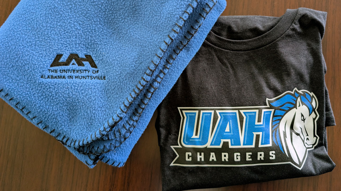 Logo stickers for U A H and Charger Athletics.